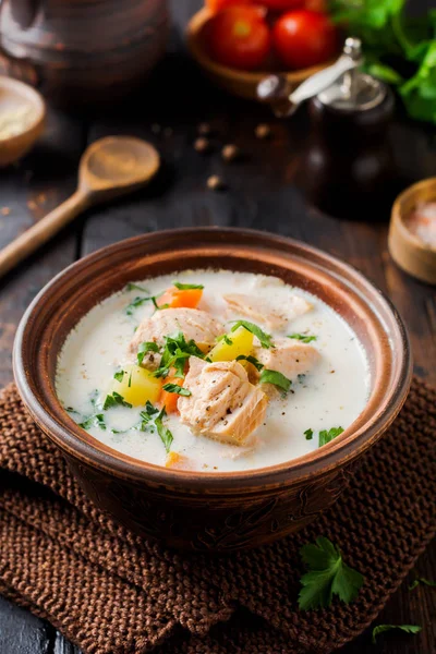 Warm Finnish creamy soup with salmon and vegetables in old ceramic bowl on old wooden background. Rustic style. — Stock Image Warm Finnish Creamy Soup Salmon Vegetables Old Ceramic Bowl Old Stock Photo