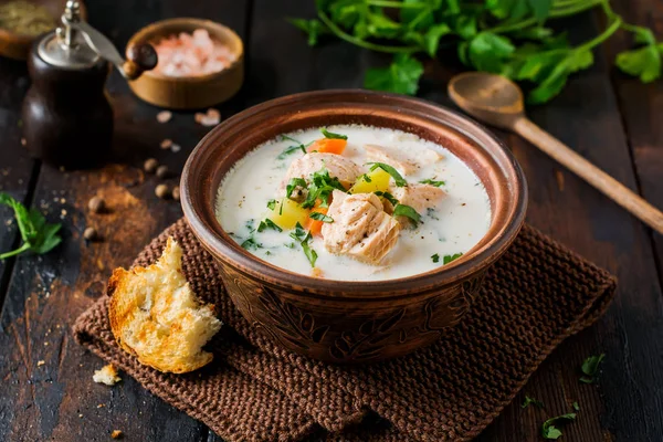 Warm Finnish creamy soup with salmon and vegetables in old ceramic bowl on old wooden background. Rustic style. — Stock Image Warm Finnish Creamy Soup Salmon Vegetables Old Ceramic Bowl Old Stock Image