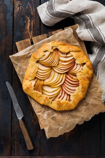 Apple galette, pie, cake with honey and cane sugar on a wooden background. Copy space. Top view