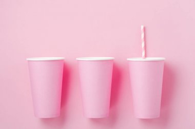 Pembe kağıt ışık arka plan üzerinde kahve üç pembe kağıt fincan. Sıfır atık kavramı. Düz yatıyordu.