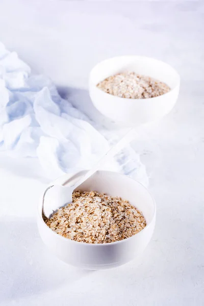 Raw Oatmeal Making Healthy Breakfast White Ceramic Bowl Light Background — Stock Photo, Image