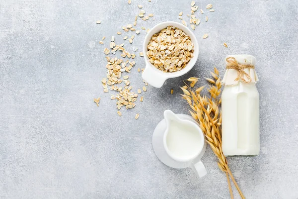 Homemade diet vegetable milk made from oatmeal on a gray background. Diet healthy concept. Copy space and Banner.Top view.