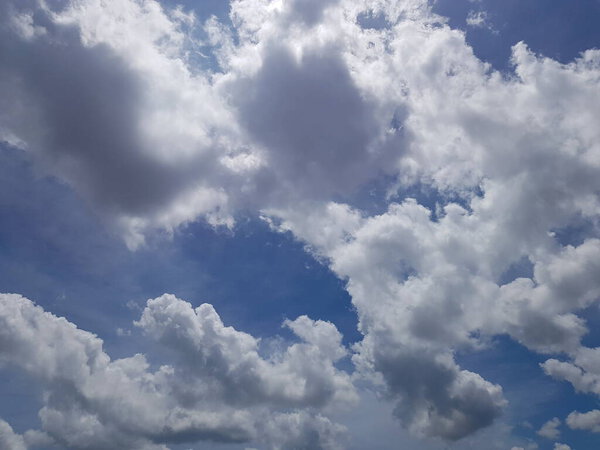 White clouds during day with clear blue sky background.