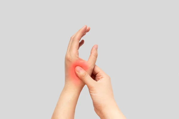 手の痛みに苦しんでいる若い女性と彼女の痛みを伴う手をマッサージ孤立灰色の背景 損傷の原因は カルパルトンネル症候群 関節炎 痛風攻撃やトリガー指が含まれています — ストック写真