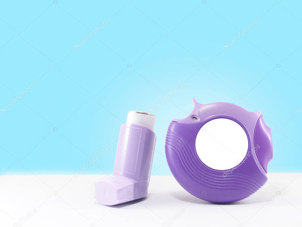 Purple asthma inhalers on white table with blue gradient background. Pharmaceutical product is used to treat lung inflammation and prevent asthma attack for asthma/COPD patients. Health medical concept.