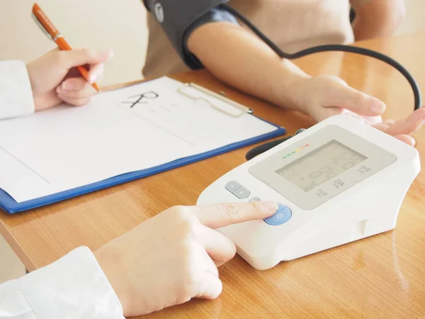 Close Female Doctor Measuring Blood Pressure Writing Prescription Hypertensive Patient — Stock Photo, Image
