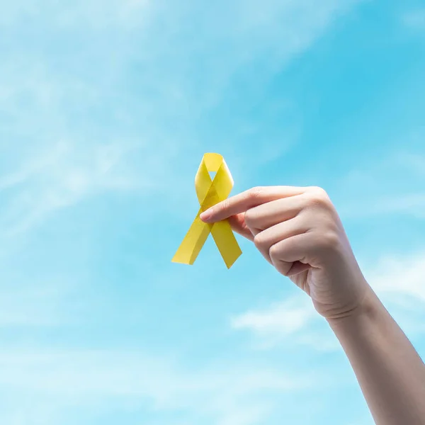 Hand Holding Yellow Gold Ribbon Awareness Blue Sky Symbol Support — Stock Photo, Image