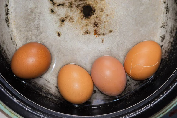 boiled eggs shell cracking in the pot