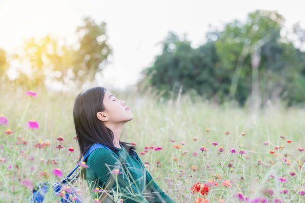 Women breathe oxygen in pure nature. Portrait woman in flower ga