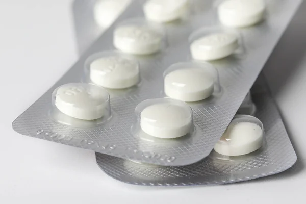 Pharmaceuticals pills medicine on white background. Capsule pill medicine. White medical pills and tablets.