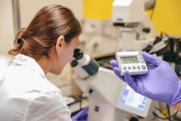 A tudósok tudományos kutatást végeznek egy mikroszkóp segítségével a laboratóriumban. — Stock Fotó