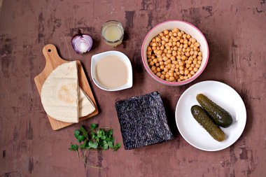Nohut, nohut, humus ve salatalık turşusu: haşlanmış nohut, tahini susam ezmesi, nori, limon suyu, kırmızı soğan, maydanoz ve pita ekmeği servis etmek için..