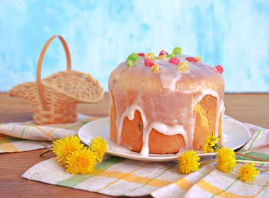 Beyaz tabakta geleneksel paskalya pastası, şekerli ve şekerli meyvelerle süslenmiş. Mutlu Paskalyalar.