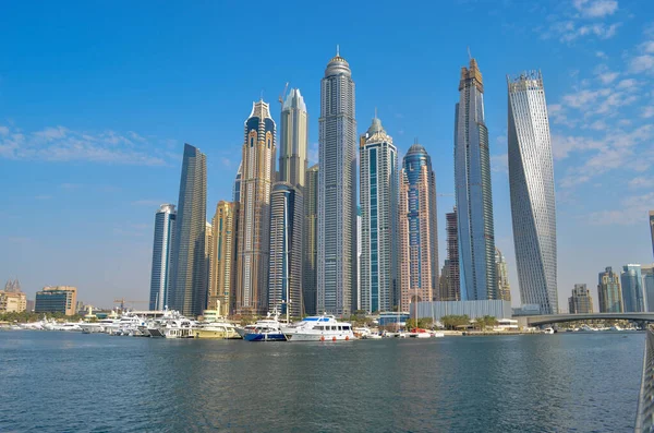 Skyscrapers in front of Dubai Marina, yacht in a sea