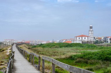 Portekiz 'in Costa Nova do Prado kentindeki Atlantik Okyanus Sahili' ne tahta kaldırım yolu.