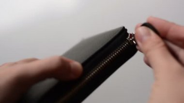 Cüzdanda 100 dolarlık banknotlar var. Cüzdandan 200 dolar öde. Kişi elinde 100 dolarlık banknotlar sayar. Beyaz arka plan. Bir tomar para. Zengin adam..