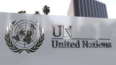 Metal Birleşmiş Milletler amblemi bir binanın ön cephesinde, BM logosu