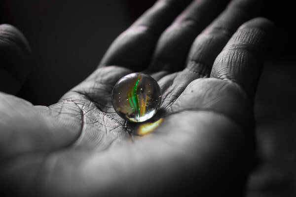 Shining Glass ball in my hand with Black & white or Monochrome filter
