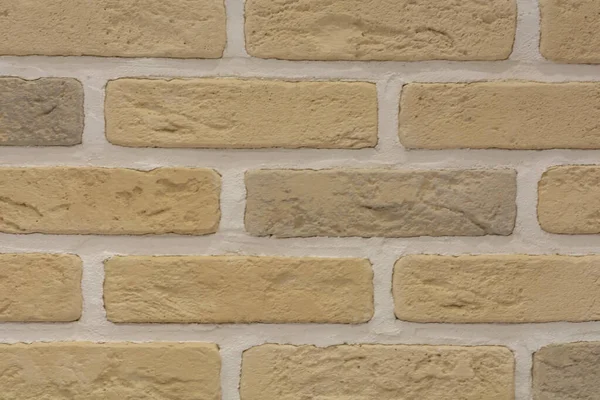 Tuğladan bir duvarın arka planı. Sarı taştan yapılmış tuğla. Temiz tuğla duvar, kopyalama alanı.