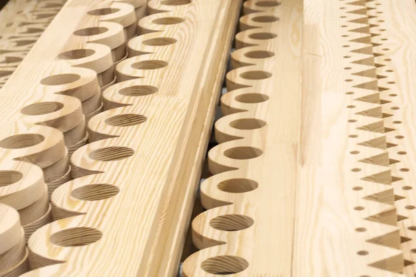 Shelving of carved wood panels in a hardware store. Decoration in the construction of wooden houses. Building material from wood, timber, boards.