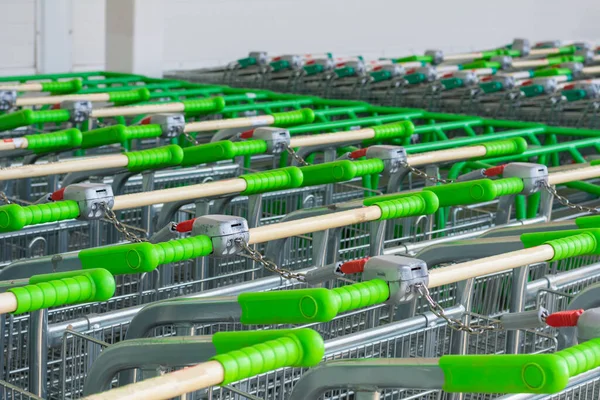 Shopping Carts Green Handles Parked Row Shopping Carts Locked — Stock Photo, Image