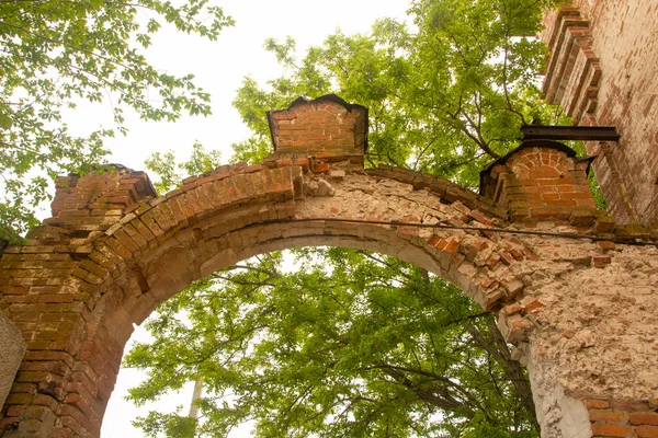 Antique brick arch with patterns over the entrance closeup. Old red brick masonry. Made at the beginning of the last century. The concept of history.