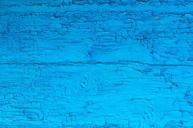 Eski mavi bir tahtanın arka planı, soyulmuş boya, doku..