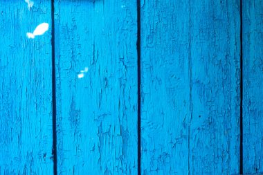 Eski mavi bir tahtanın arka planı, soyulmuş boya, doku..