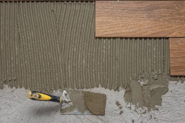 Seramik fayanslar ve tiler için aletler. Döşeme döşemesi. Ev tadilatı, yenileme - seramik fayans döşeme tutkalı, havan topu, seviye.