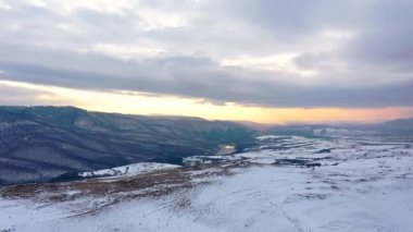 Kışın kar üzerinde altın bir gündoğumu havadan görünümü.