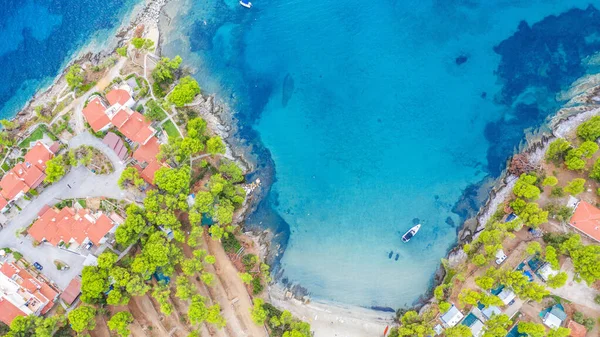 Aerial sunset view of amazing Neos Marmaras cityscape and distant turtle island in Greece.