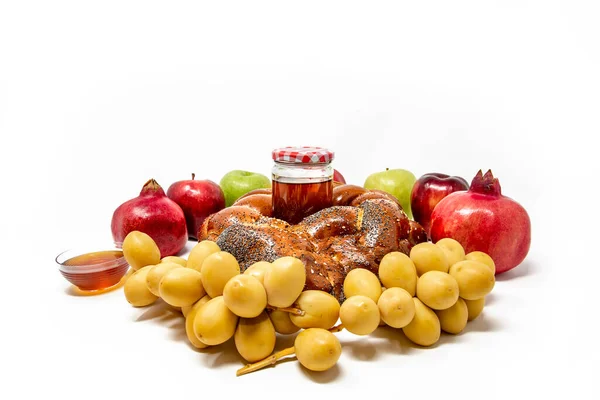 Rosh Hashanah, Jewish New Year, Traditional Symbols, Honey in a glass jar, Pomegranates, Dates, Red And Green Apples, Challah Bread