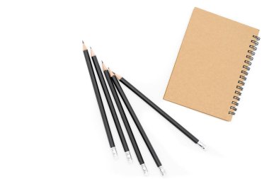 Resmin sağ köşesindeki kahverengi defter ve kitabın sol tarafındaki siyah kalem, hepsi beyaz arka plana yerleştirilmiş..