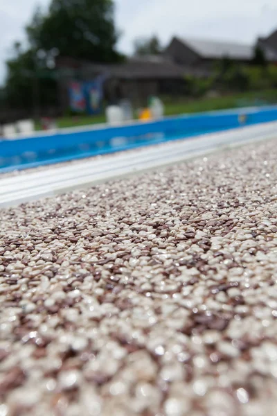 Texture of pebbles in an exposed aggregate foundation