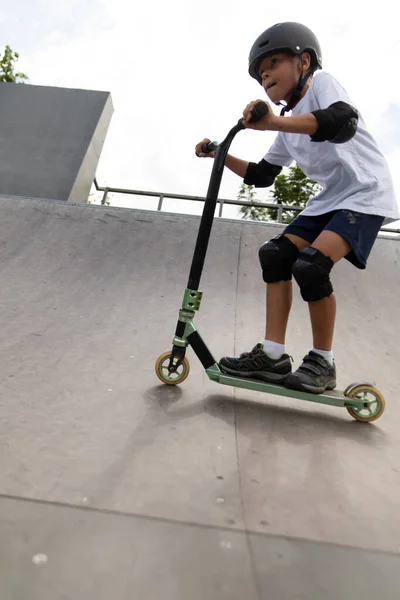 Cute Little Boy Rides Scooter Skatepark Young Novice Athlete Spends — Stock Photo, Image