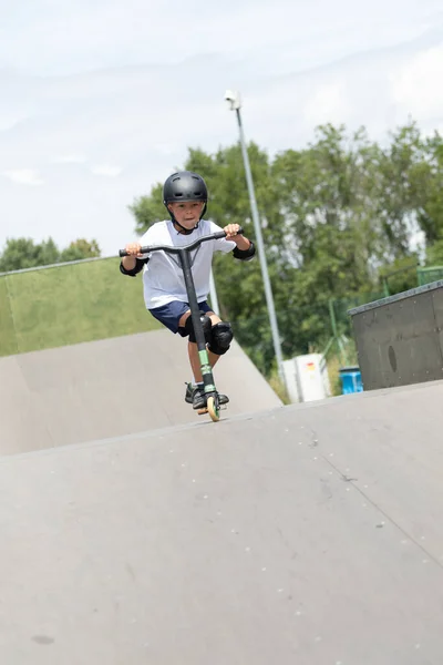 Cute Little Boy Rides Scooter Skatepark Young Novice Athlete Spends — Stock Photo, Image