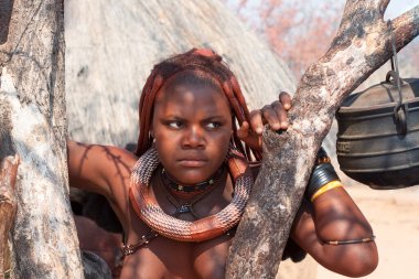 Otjikandero Himba Köyü, Namibya - 8 Eylül 2017: Afrika Himba kabilesi genç kadın milli mücevher kolyeleri ve bilezikleri ile geleneksel saç stili portresi