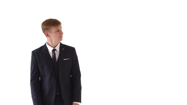 Portrait of a serious, handsome, attractive, fashionable, modern businessman, pointing to blank space, isolated on a white background in studio — Stock Video