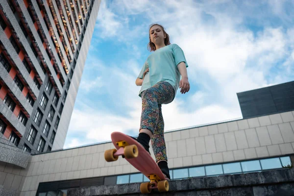 Güzel genç kız güneşli bir günde sokakta elinde bozuk para tahtasıyla dikiliyor.