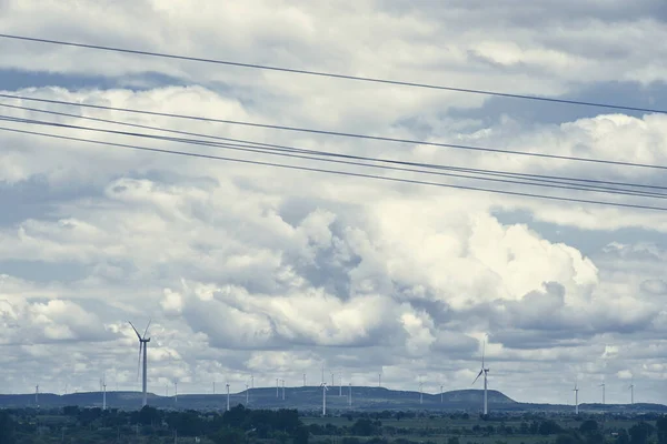 The wind power stations on the hill generating clean energy, against the climate change