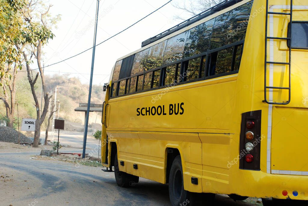 yellow school bus in rural village road