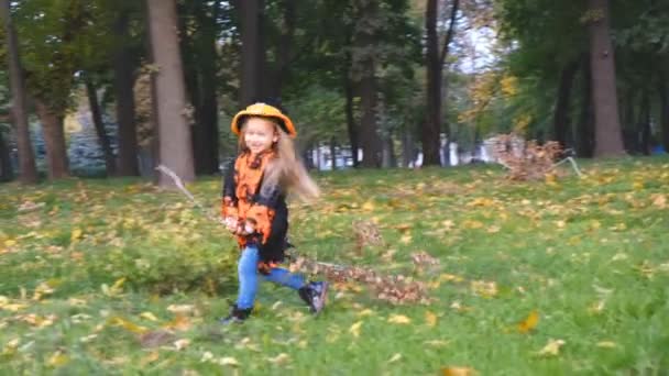 女孩巫婆运行与扫帚在公园在万圣节秋季 — 图库视频影像