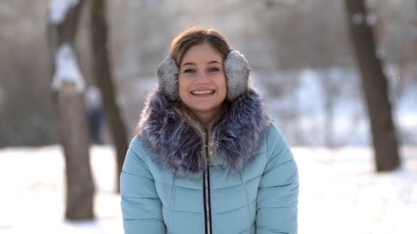 Bela jovem diversão joga neve no parque para cima — Vídeo de Stock