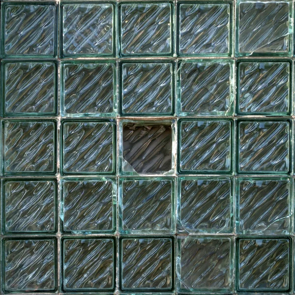 Green glass blocks wall pattern. Industrial background.