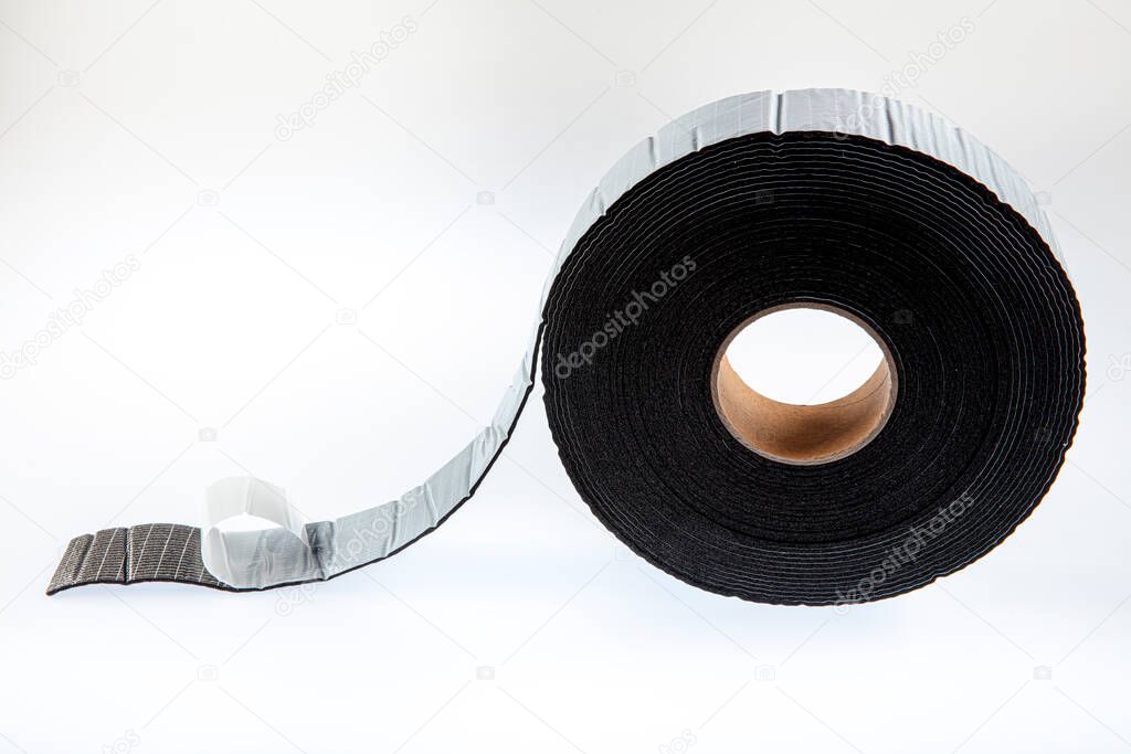 Black industrial tape in roll on white background. Rubber insulating tape. Sound insulation adhesive tape.