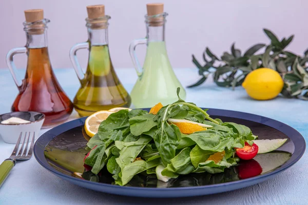 Arugula salad. Rocket salad with Parmesan cheese, lemon, olive oil and seasonings on wooden background. Vegetarian food
