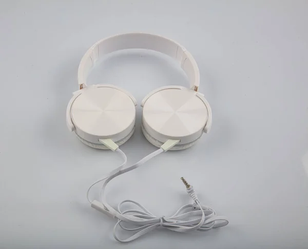 Stereo headphones. Top view of white headphones on white background with copy space. Flat lay.