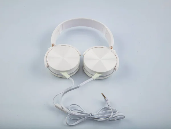 Stereo headphones. Top view of white headphones on white background with copy space. Flat lay.
