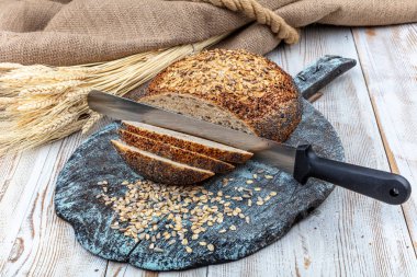 Taze ev yapımı ekmek. Fransız ekmeği. Kırsal masada ekmek dilimi ve bıçak kesme.. 