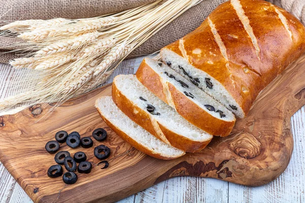 Olive-Rosemary Bread, Italian specialty, isolated on wooden background.